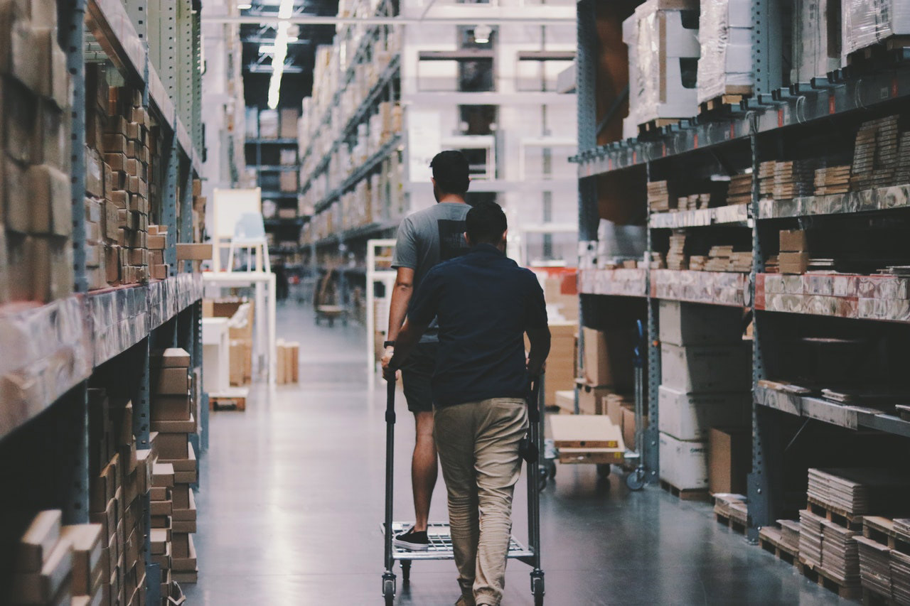 People walking in a warehouse.