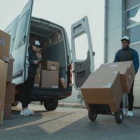 Two men unloading a moving van.